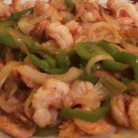 Arroz Con Camarones · Sauteed shrimp, onion, green peppers and mushrooms served on a bed of rice topped with melte...
