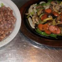 Vegetable Fajitas · Sauteed green peppers and onion served on a sizzling platter with rice beans, sour cream, gu...