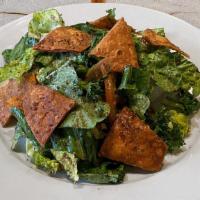 Fattoush  · Romaine lettuce, tomatoes, cucumbers, parsley, sumac, pita chips with a tangy pomegranate mo...