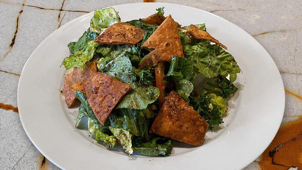 Fattoush  · Romaine lettuce, tomatoes, cucumbers, parsley, sumac, pita chips with a tangy pomegranate molasses dressing. New!