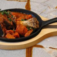 Lamb Shank · Tender whole lamb shank served with homemade tomato sauce, steamed veggies, and basmati rice...