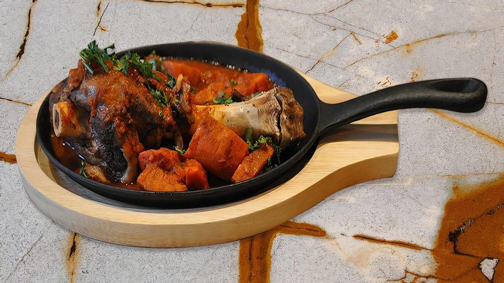 Lamb Shank · Tender whole lamb shank served with homemade tomato sauce, steamed veggies, and basmati rice on the side. Comes with one pita bread.