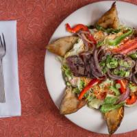 Coyote Steak Salad · Salad greens, peppercorn ranch, peppers, cheese, grilled onions and a 6 ounce top sirloin