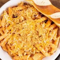 Baked Mac Mac Chili Bowl · Penne pasta tossed in a creamy cheese sauce with choice of our house-made chili or Vegetaria...