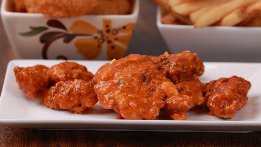 Boneless Wings - 6 Pieces · (6) Large all white meat Boneless Wings, lightly battered and flash fried.  All the fun with the fuss! Served with a ranch. Choice of: Naked, Honey BBQ (extra charge), Buffalo Medium Wing Sauce (extra charge)