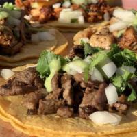 Street Taco · Corn or flour tortillas, choice of meat or veggie, topped with onion, cilantro and guacamole