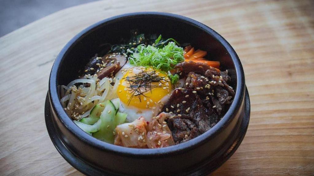 Stone Bowl Bibimbap · Rice with marinated spinach, bean sprout, zucchini, kimchi, mushroom, cucumber, mix salad, nori, sesame seed, sesame oil and green onion sunny side egg on top with Korean spicy sauce. Served with miso soup.
