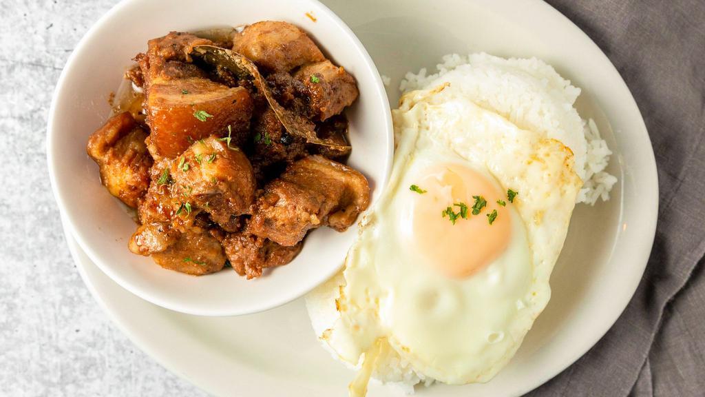 Pork Adobo · Pork meat slowly cooked in vinegar and soy. Served with rice or garlic fried rice and egg.