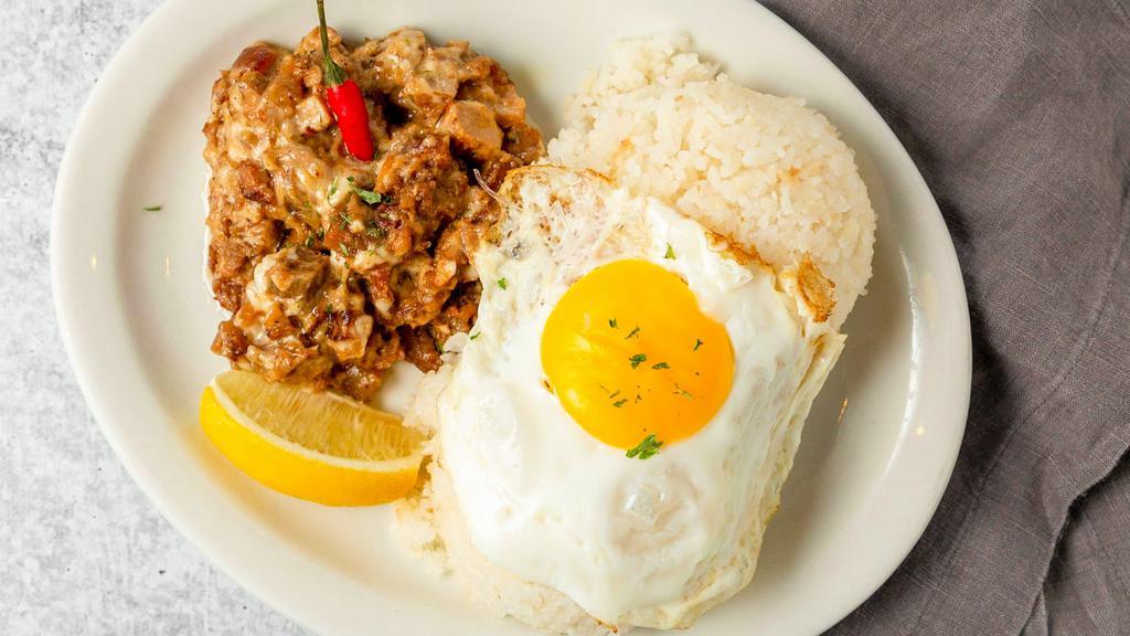 Pork Sisig · Minced pork belly, seasoned with lemon. Served with rice or garlic fried rice and egg.