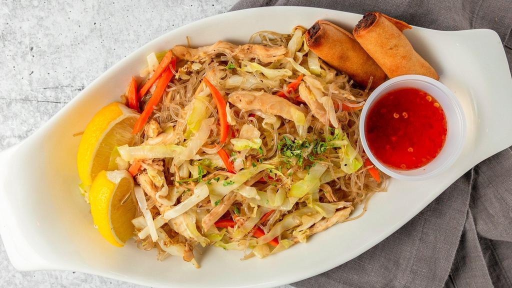 Pancit · Philippines noodle dish. Stir fried noodles with chicken meats and vegetables, comes with two pieces of spring rolls.