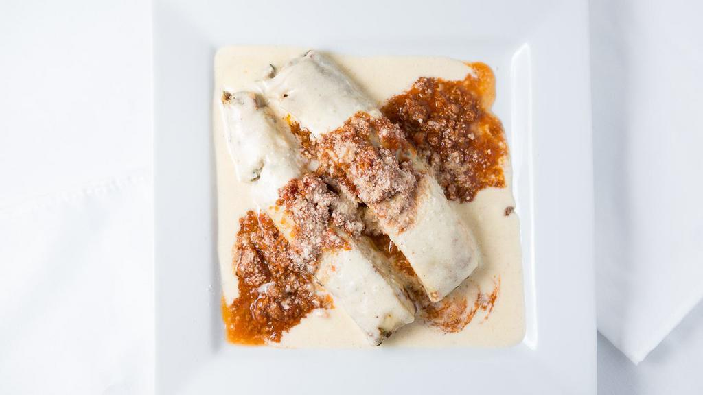 Cannelloni Fiorentina · pasta crepe filled with chicken, veal, spinach, & topped with béchamel sauce