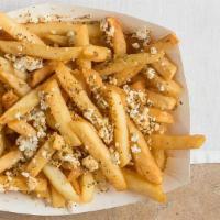 Greek Fries · French fries drizzled with olive oil and lemon, Greek spices, and feta cheese; served with o...