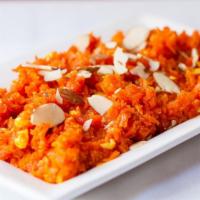 129) Carrot/ Gajar Halwa · Grated carrot pudding mixed with nuts and raisins.