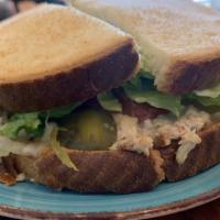 Tuna Melt Sandwich Includes Chips · Tuna, swiss cheese, pickles, tomato and lettuce. On white or sourdough bread.