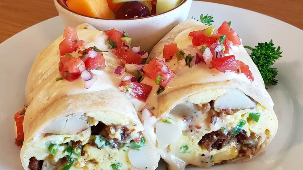 Breakfast Burrito · Cheesy, bacon potato breakfast burrito. Stuffed with bacon, eggs, our house made gourmet thick cheese sauce, green onions,Cheddar Cheese and seasoned potatoes, topped with pico de Gallo and served with fresh fruit.