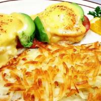 Eggs Benedict · Canadian bacon, two poached eggs, and hollandaise sauce over an English muffin served with h...