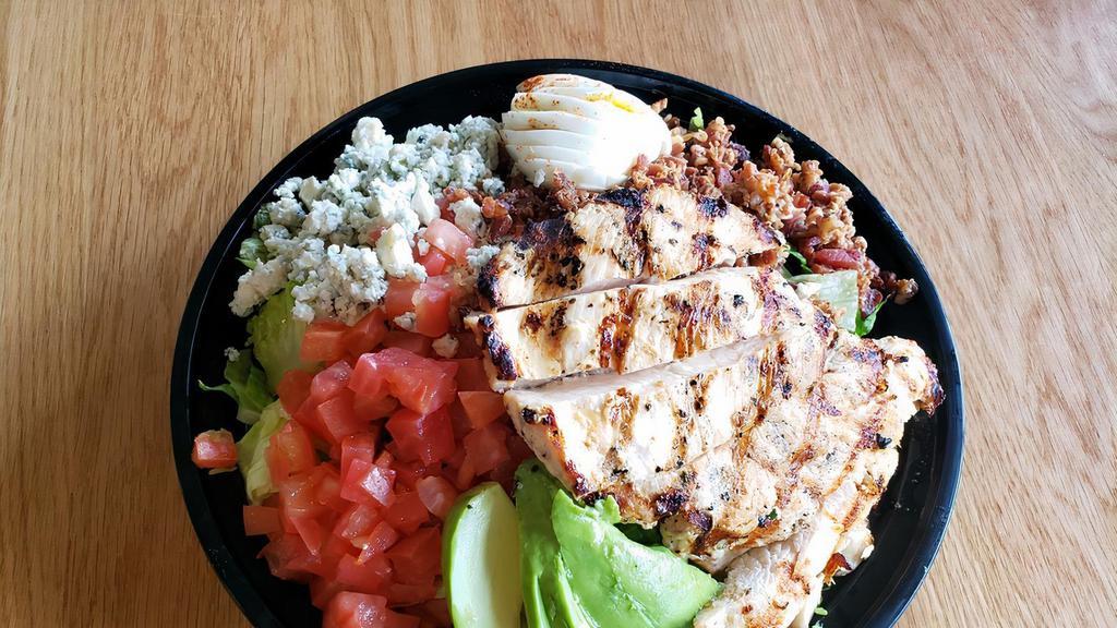 Cobb Salad · Tender grilled chicken breast on fresh garden greens with bacon, avocado, tomatoes, blue cheese and a hard boiled egg.