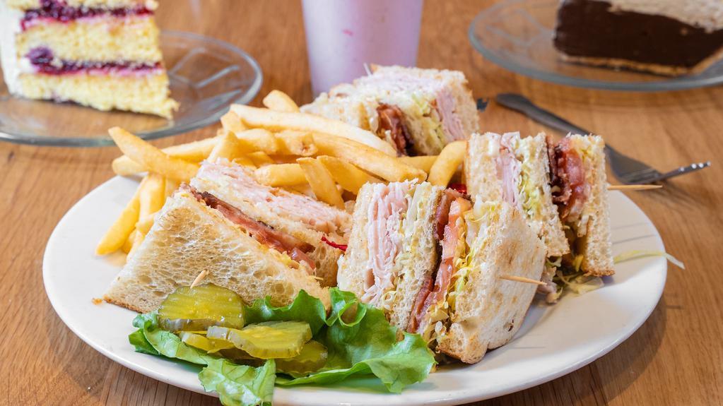 Clubhouse Sandwich · Triple decker with smoked turkey, bacon and tomatoes. Choice of bread. Choice of sides.