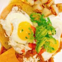 Huevos Rancheros · Two filled tortillas topped with green and red Salsa, two sunny up eggs. Fresh cheese and Av...