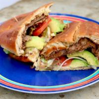 Torta Milanesa · Mexican sandwich w. Breaded and fried steak, beans , tomato, onion, fresh jalapeno, cheese a...