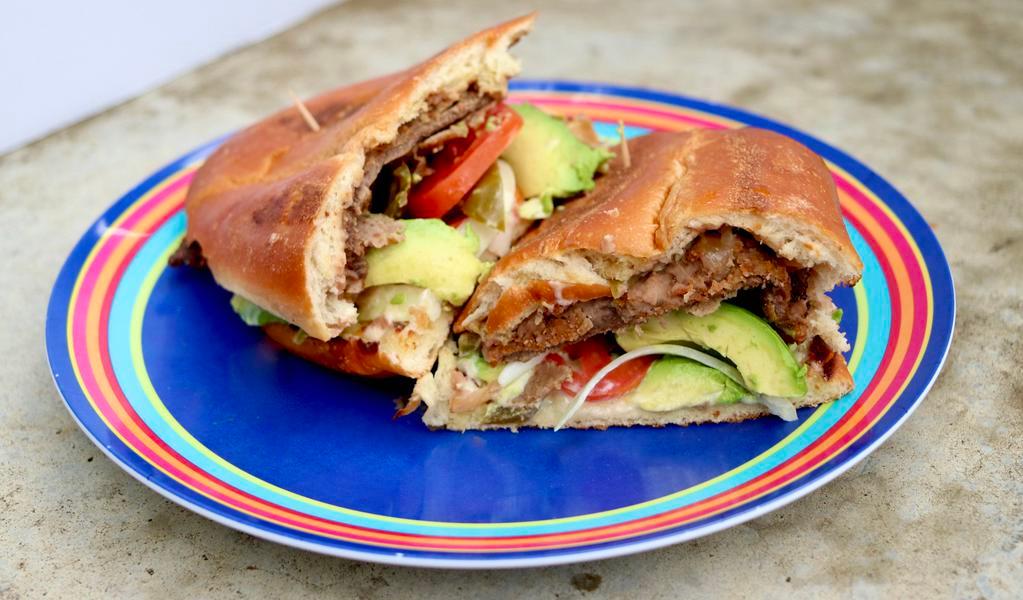 Torta Milanesa · Mexican sandwich w. Breaded and fried steak, beans , tomato, onion, fresh jalapeno, cheese and mayo.