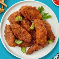 Mango Habanero Wings · Fresh chicken wings breaded, fried until golden brown, and tossed in mango habanero sauce. S...