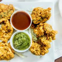 Vegetable Pakore · Potato and florets of cauliflower, fried in chickpea batter.