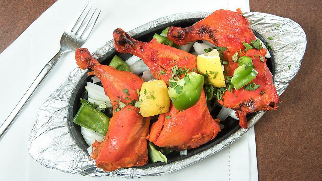 Tandoori Chicken · Half chicken marinated in yogurt and spices then barbecued in our traditional clay oven.