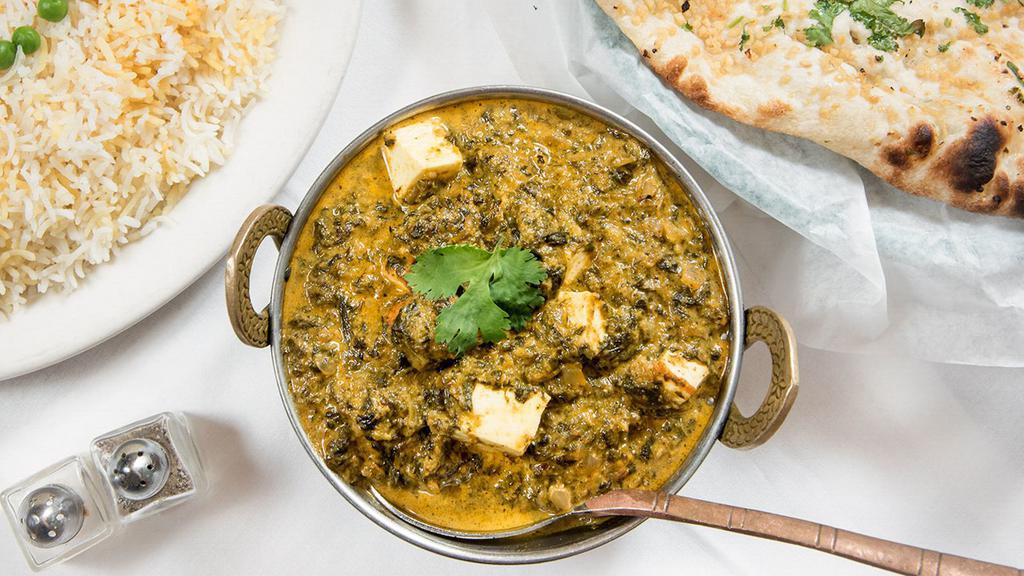 Saag Paneer · Homemade cheese and spinach sautéed with a touch of cream and curry sauce. A must in every Indian feast.