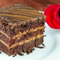 Chocolate Cake · Sponge Swiss chocolate cake, layered with sweet caramel and finished with dark chocolate cre...