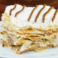Milhojas · Four layers of puff pastry, covered with sweet caramel and finished with whipping cream on top