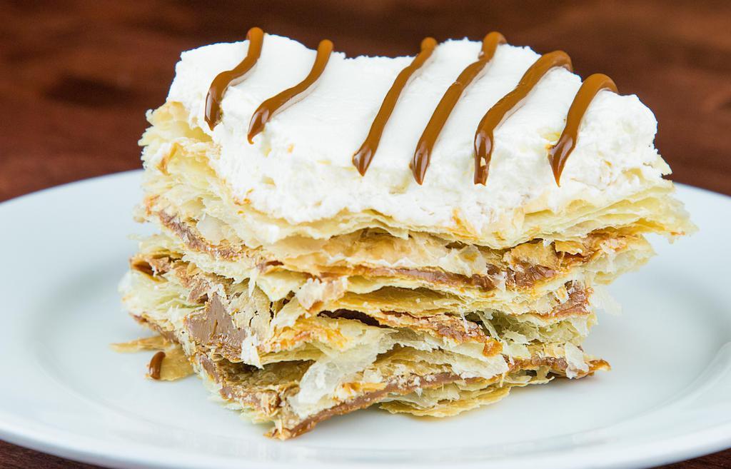 Milhojas · Four layers of puff pastry, covered with sweet caramel and finished with whipping cream on top