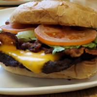 Bacon Cheddar Burger · 1/2 pound hand made beef pattie with cheddar cheese , onions , lettuce & tomatoes on a potat...