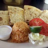 Quesadilla · Corn hand made comes with beans and cheese, served with lettuce, tomato and sour cream.