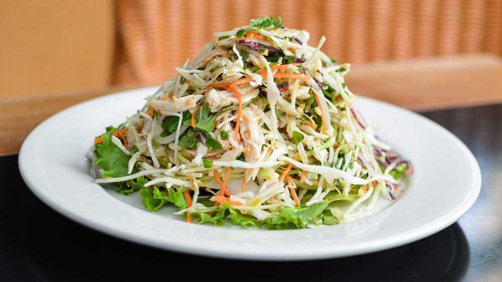 Chicken Chieu · Thinly sliced green and red cabbage, carrot, cilantro, tri-mint, peanuts and fried shallots topped with poached chicken and served with a slightly spicy Vietnamese dressing.