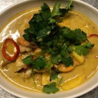 Pineapple Curry Prawns · Wok-fried prawns in a coconut-based curry with lemongrass, turmeric, red chili, and fresh pi...