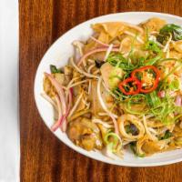Seafood Thai Noodle · Wide rice noodles are wok-fried with prawns and  squid, light soy sauce with hints of basil ...