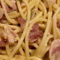 Spaghetti Carbonara · Traditional sauce, onions, pancetta, egg yolk and white wine sauce.