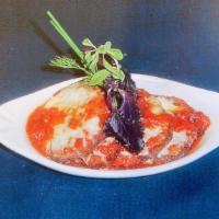 Parmigiana Di Melanzane · Breaded and fried eggplant baked with tomato, mozzarella and Parmesan cheese.