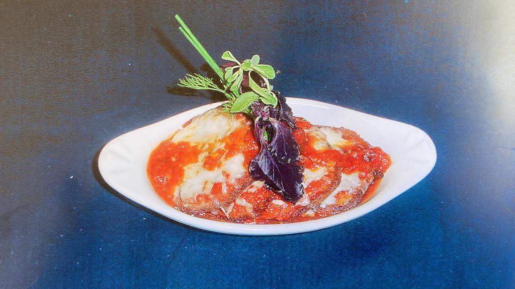 Parmigiana Di Melanzane · Breaded and fried eggplant baked with tomato, mozzarella and Parmesan cheese.