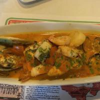 Cioppino Al Viareggio · Assorted of clams, mussels, shrimps, scallops, and fish in a light tomato broth.