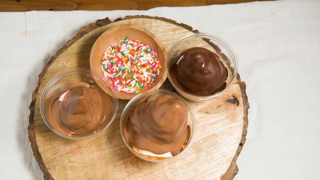 Dipped Ice Cream · A cup of your choice of soft ice cream topped with Belgian Chocolate