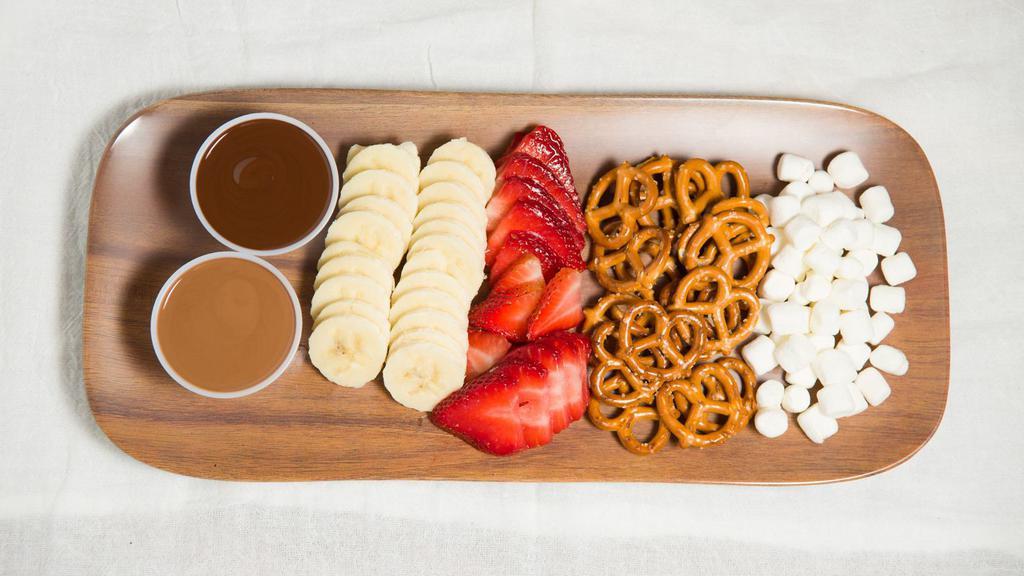 Chocolate Fondue · Pick 2 types of chocolate. Comes with bananas, strawberries, pretzels and marshmallows.