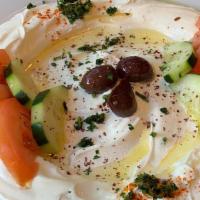 Labnie · Drained yogurt topped with olives, olive oil, tomatoes, and cucumbers. Served with two warm ...