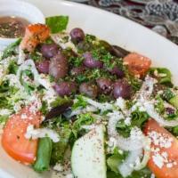 Greek Salad · Tossed crisp mixed greens with tomatoes, onion, cucumber, feta cheese, and Kalamata olives. ...