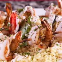 Prawns Kabob · Prawns seasoned in our house spices. Served over a bed of rice, with charbroiled Veggie Kabo...