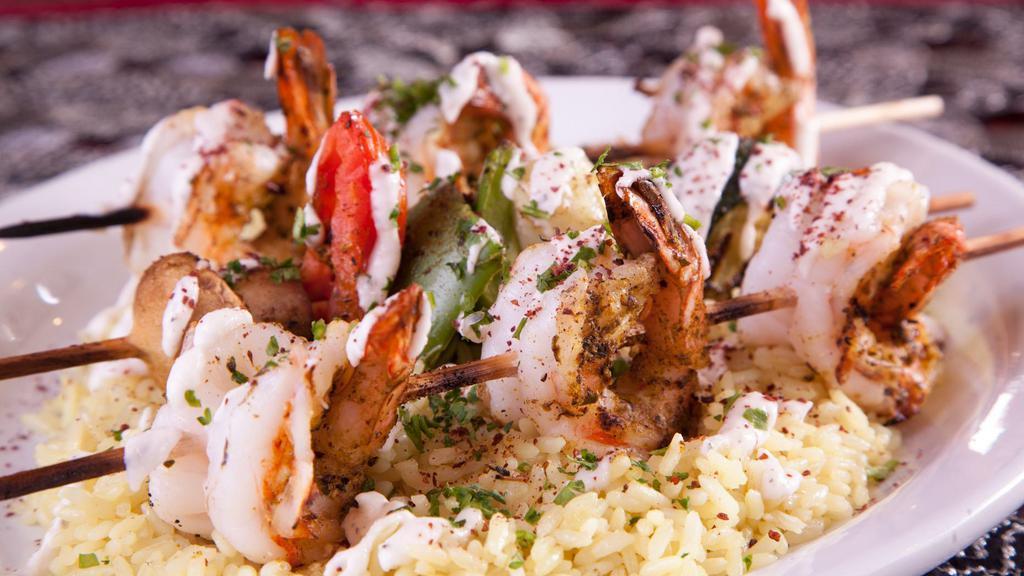 Prawns Kabob · Prawns seasoned in our house spices. Served over a bed of rice, with charbroiled Veggie Kabob. topped with Garlic sauce.