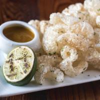 Housemade Pork Rinds · With grilled lime and Crystal Hot Sauce; Gluten Free