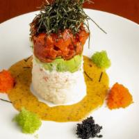 Ahi Tower · Layered spicy sesame tuna, avocado, crab salad, rice, creamy wasabi, and tobiko.