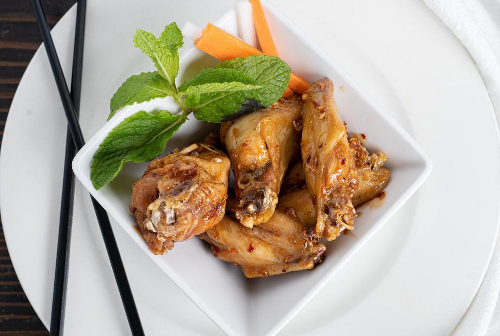 Garlic Wings · Vietnamese-style fried chicken wings sautéed in spicy garlic fish sauce.